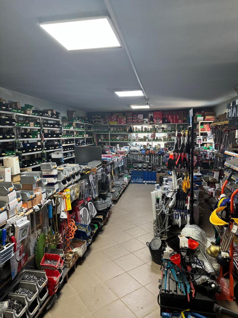 Interiorul magazinului, cu rafturi de șuruburi, piulițe și feronerie